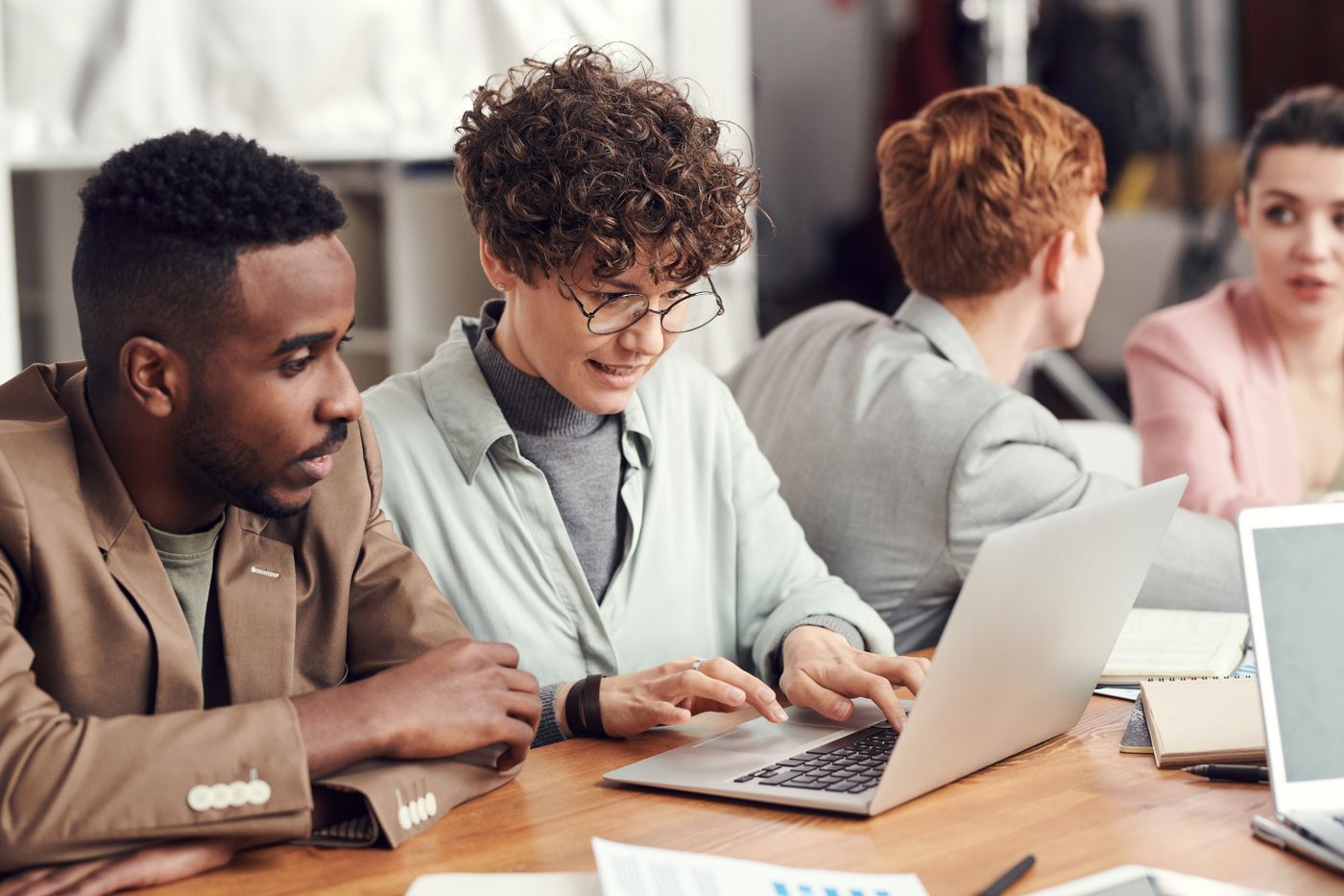 A diverse business team reviewing work on a laptop